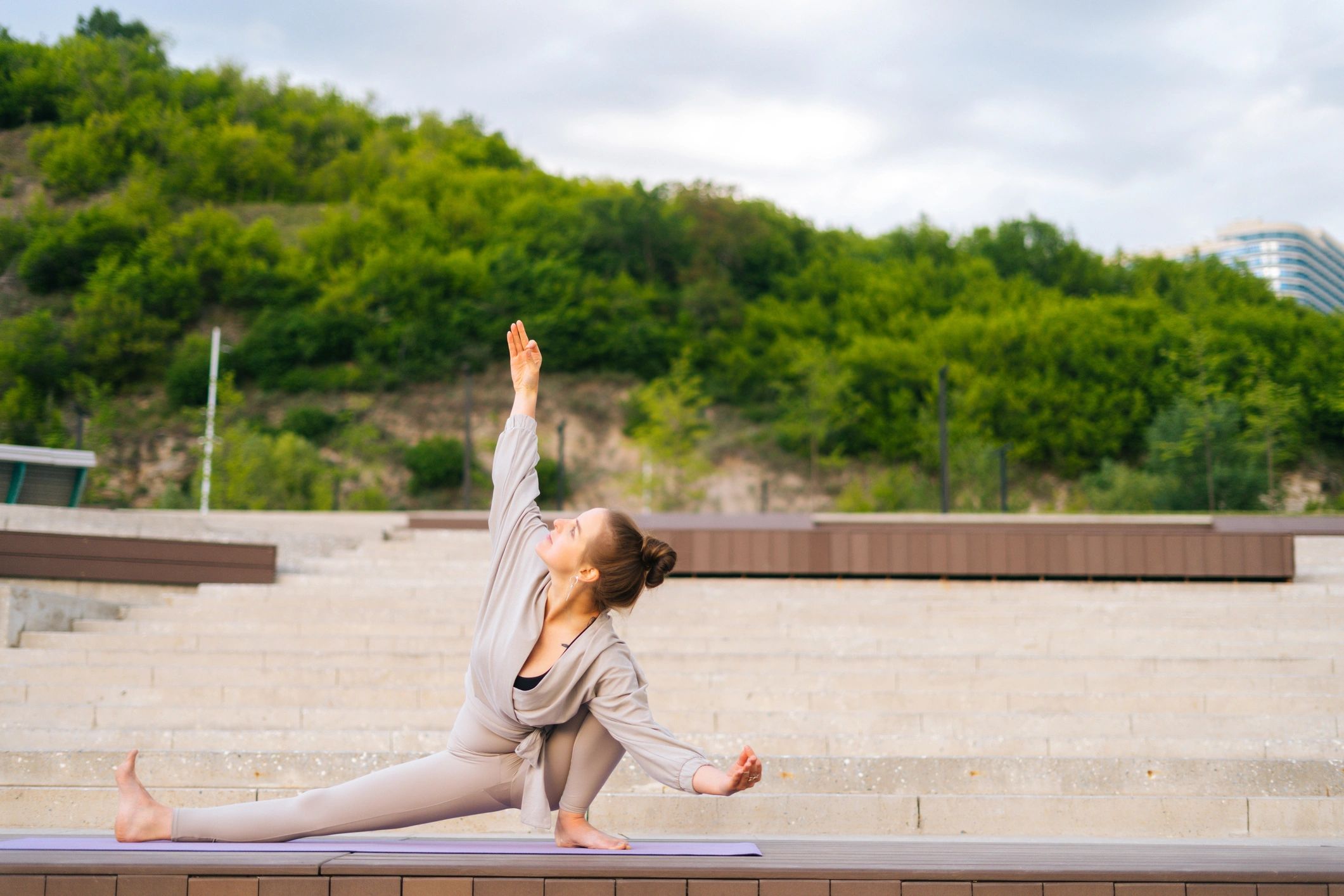 Woman practicing yoga outdoors in a peaceful park