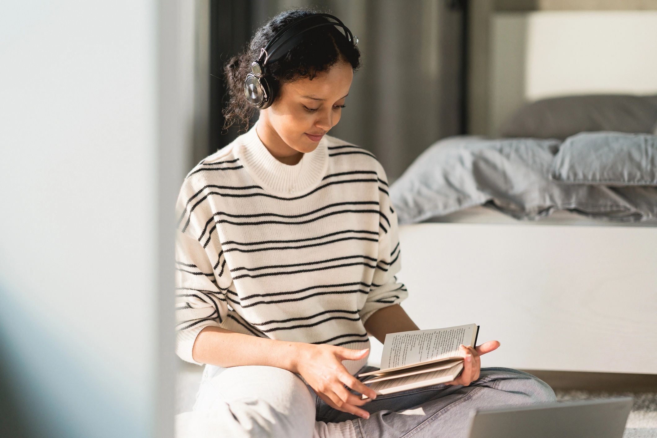 Woman reading and journaling in a calm home setting